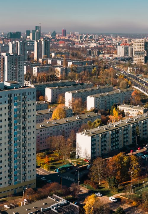 Free Aerial view of residential buildings in Poznań, Poland, showcasing autumn colors and urban landscape. Stock Photo