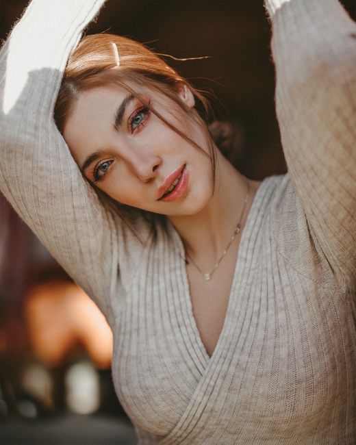 A captivating portrait of a woman with a warm, serene expression, showcasing graceful elegance and natural beauty.