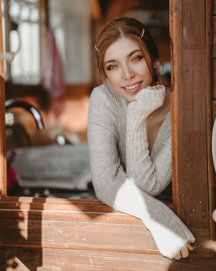 Woman Wearing Gray Sweater While Smiling