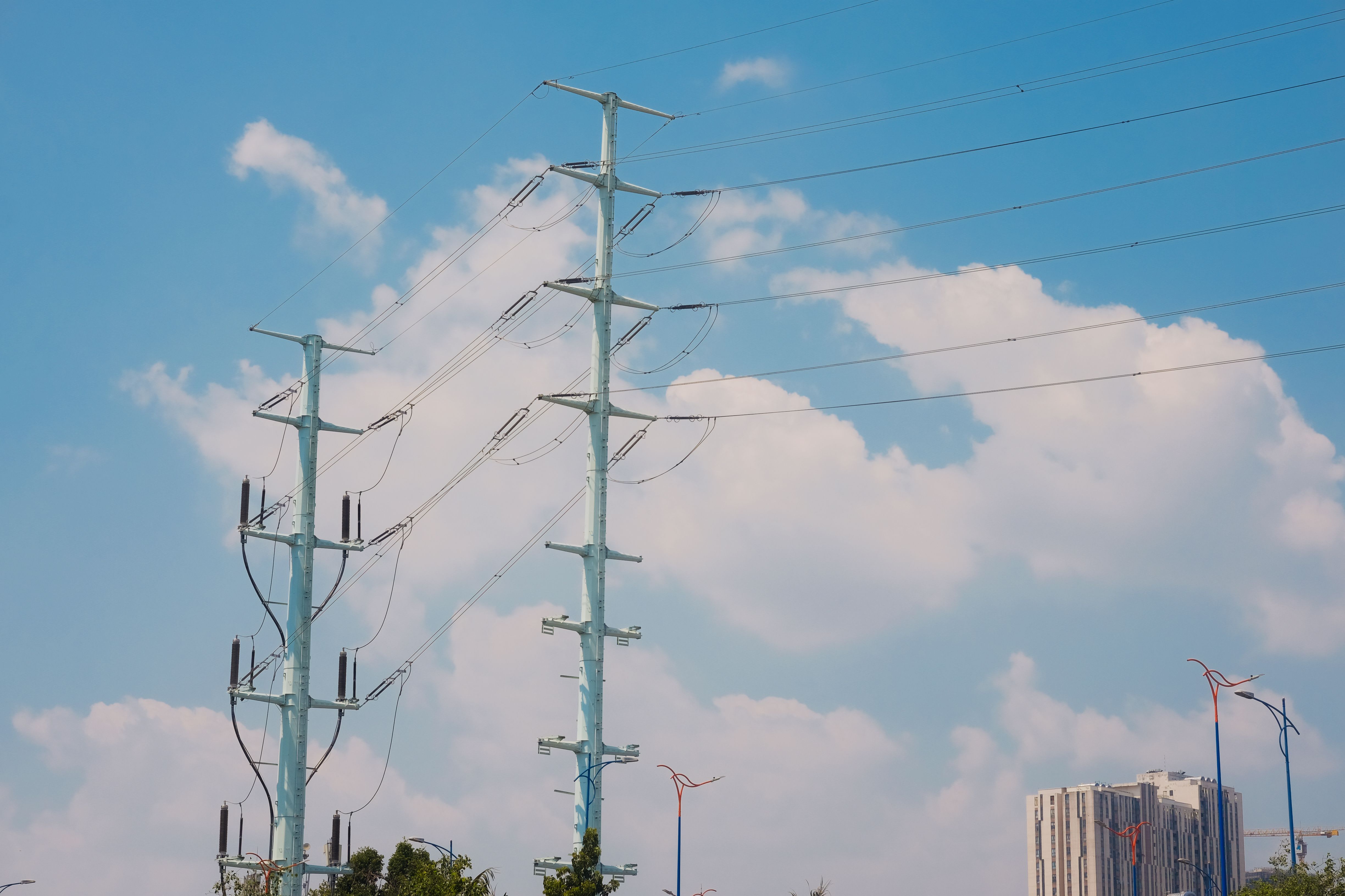 High Voltage Power Lines against a Clear Blue Sky · Free Stock Photo