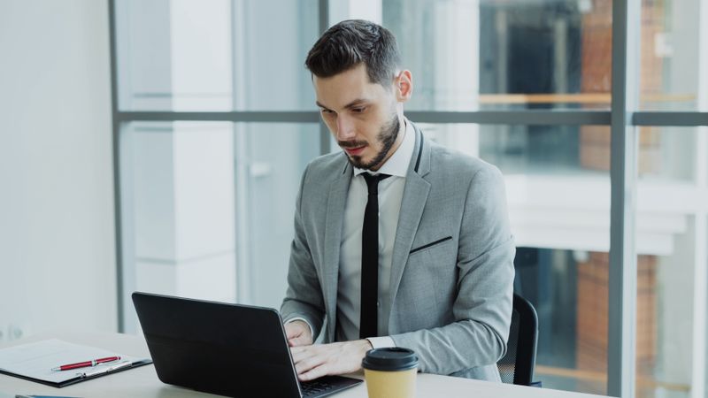 Business owner working on a laptop in a modern office