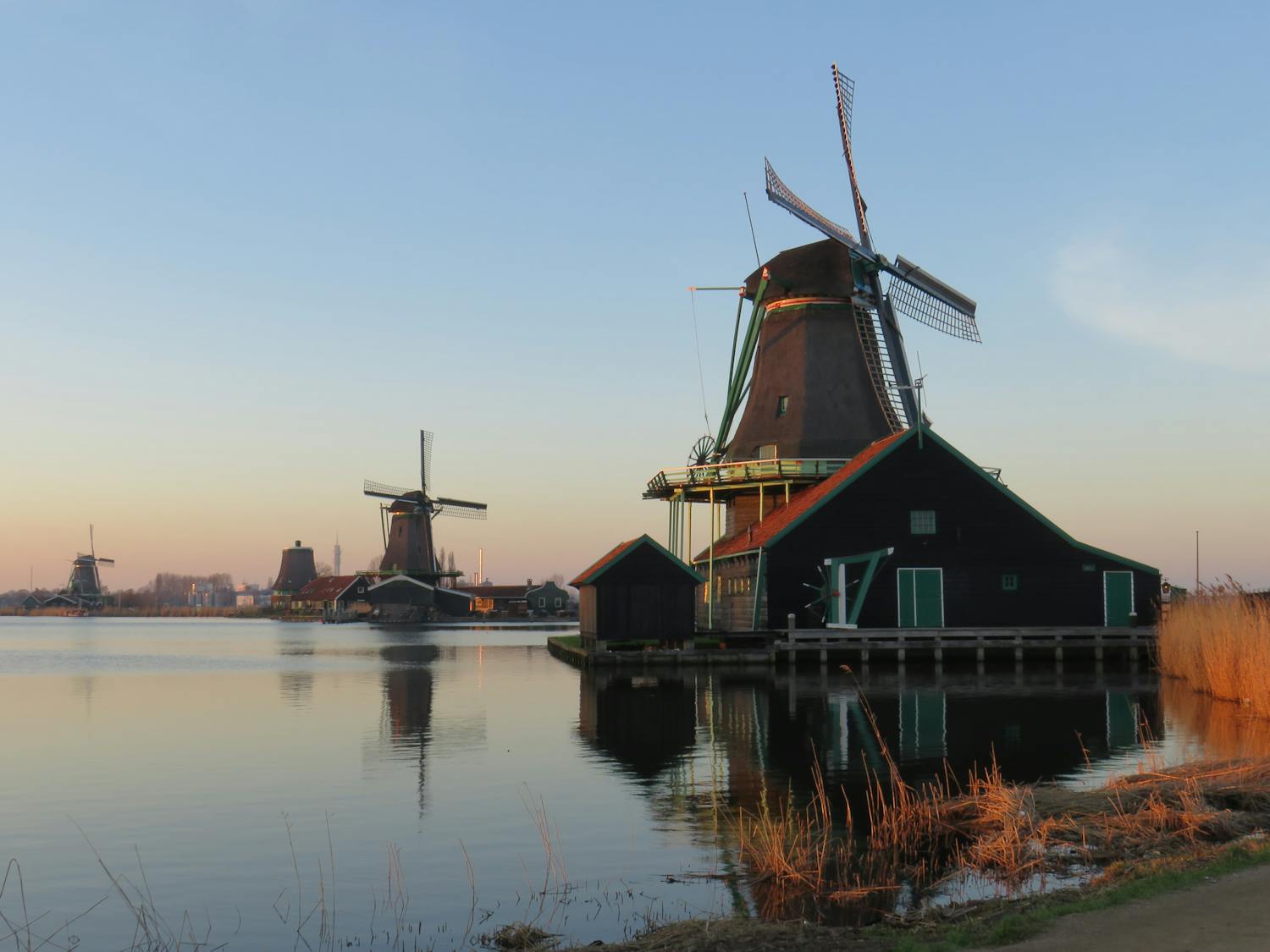 Scenic view of traditional Dutch windmills reflecting on the water