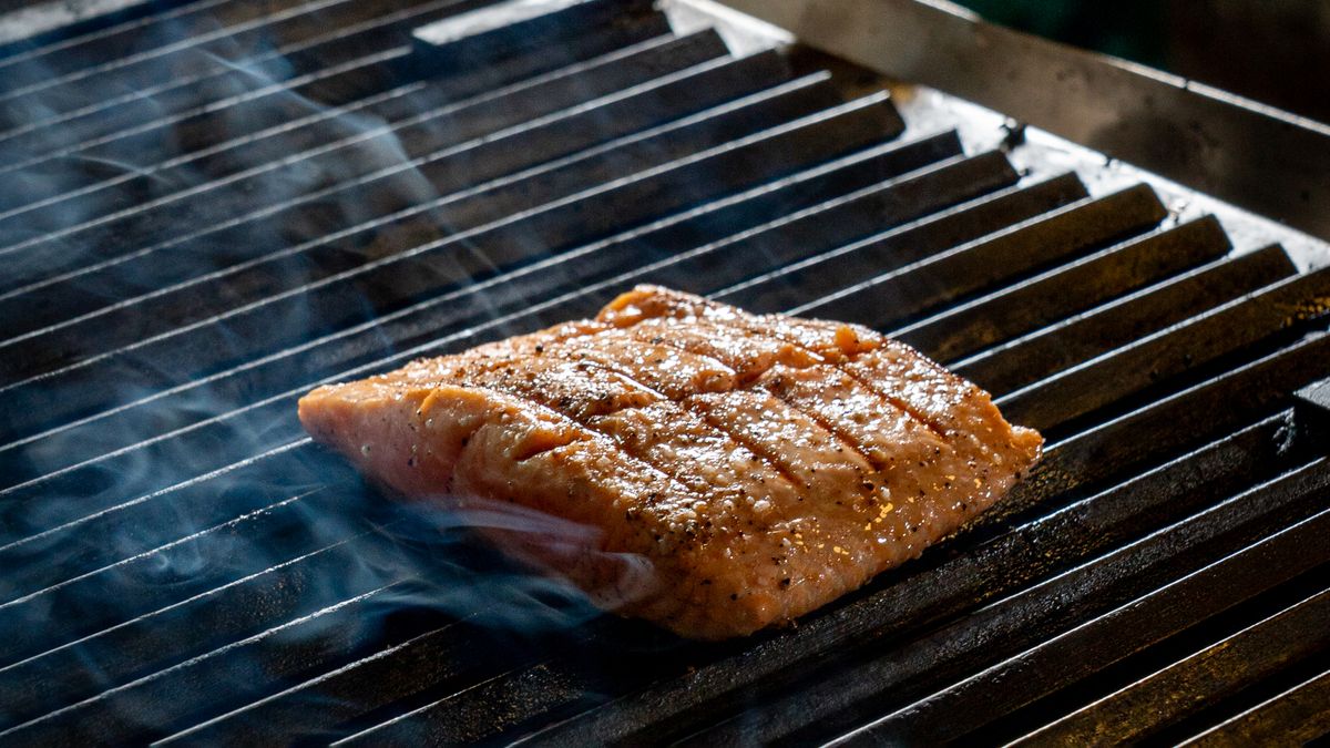 A grilled salmon fillet on a barbecue grill, a dietary source of omega-3