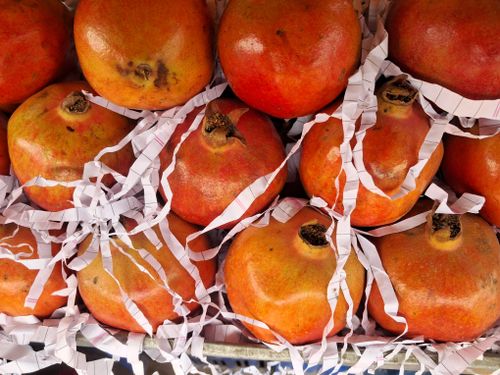 Free A vibrant display of fresh pomegranates arranged together, showcasing their rich red colors. Stock Photo