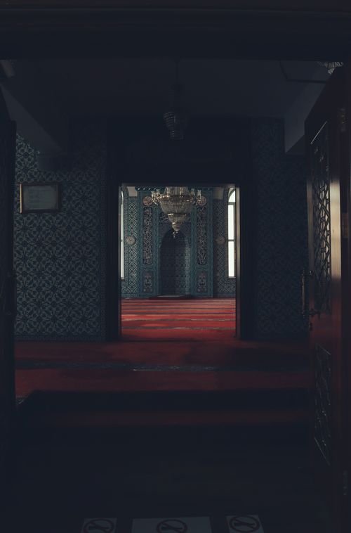 Free Intricate mosque interior with rich patterns and an opulent chandelier, showcasing Islamic architecture. Stock Photo
