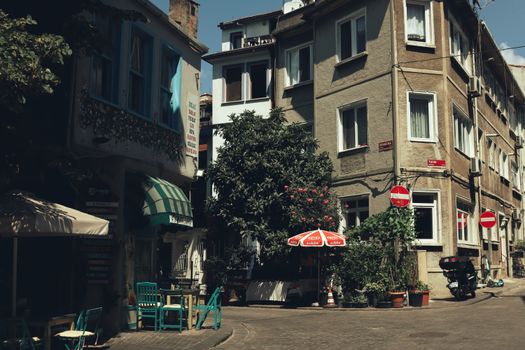 Historic urban street view with quaint café, colorful buildings, and charming outdoor seating.