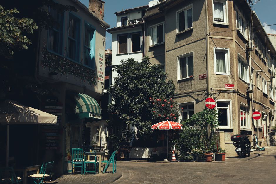 Historic urban street view with quaint café, colorful buildings, and charming outdoor seating.