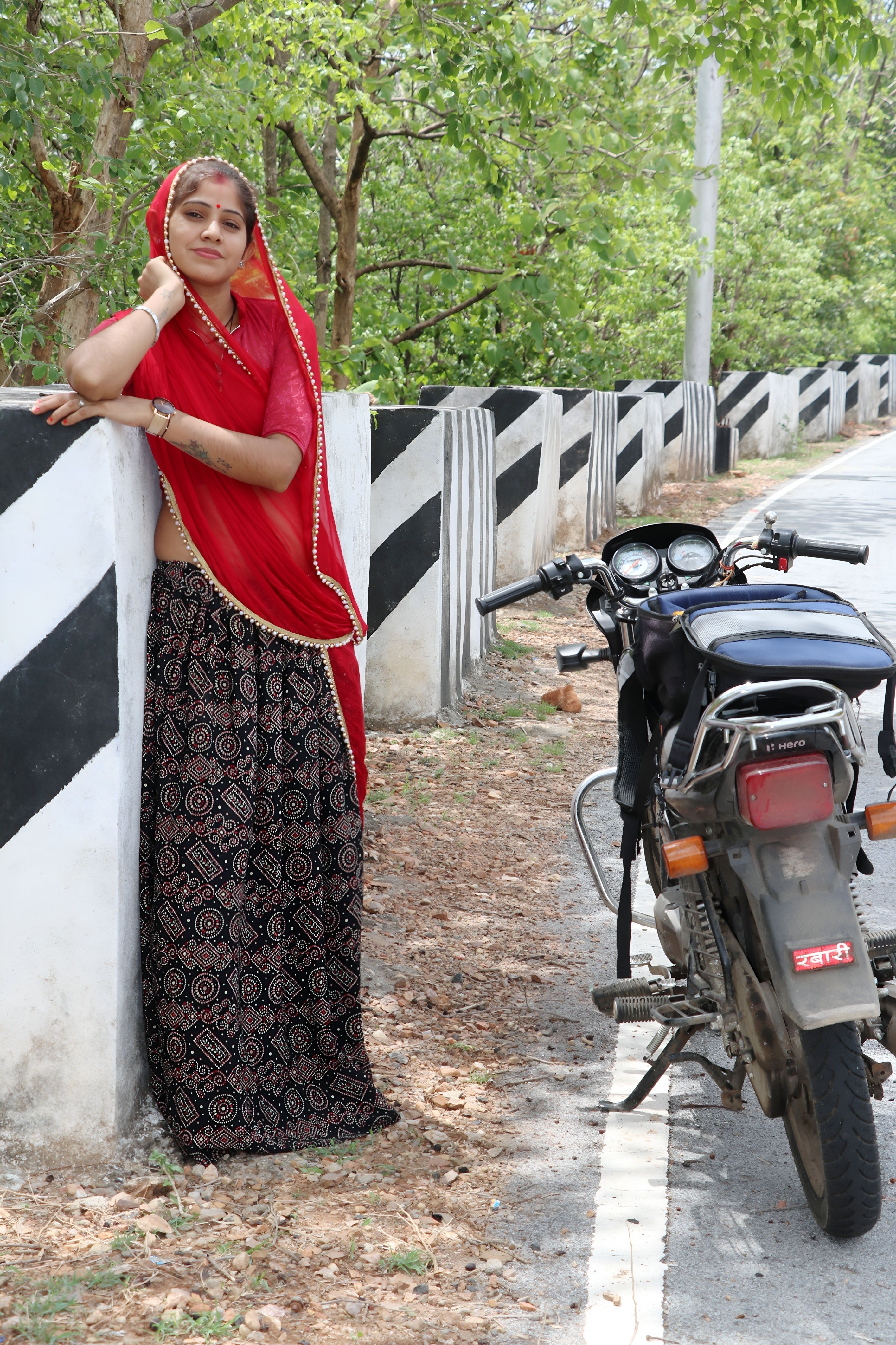 Woman in Traditional Attire Beside Motorcycle · Free Stock Photo
