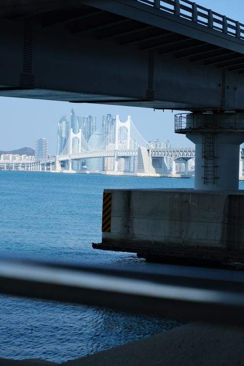 Free A unique perspective of Busan's Gwangan Bridge with modern cityscape in the background. Stock Photo