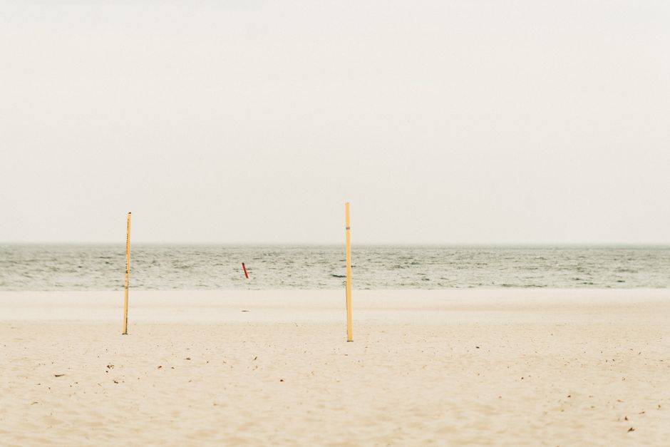 Serene view of an empty beach under a cloudy sky in Gdynia, Poland, ideal for meditation.