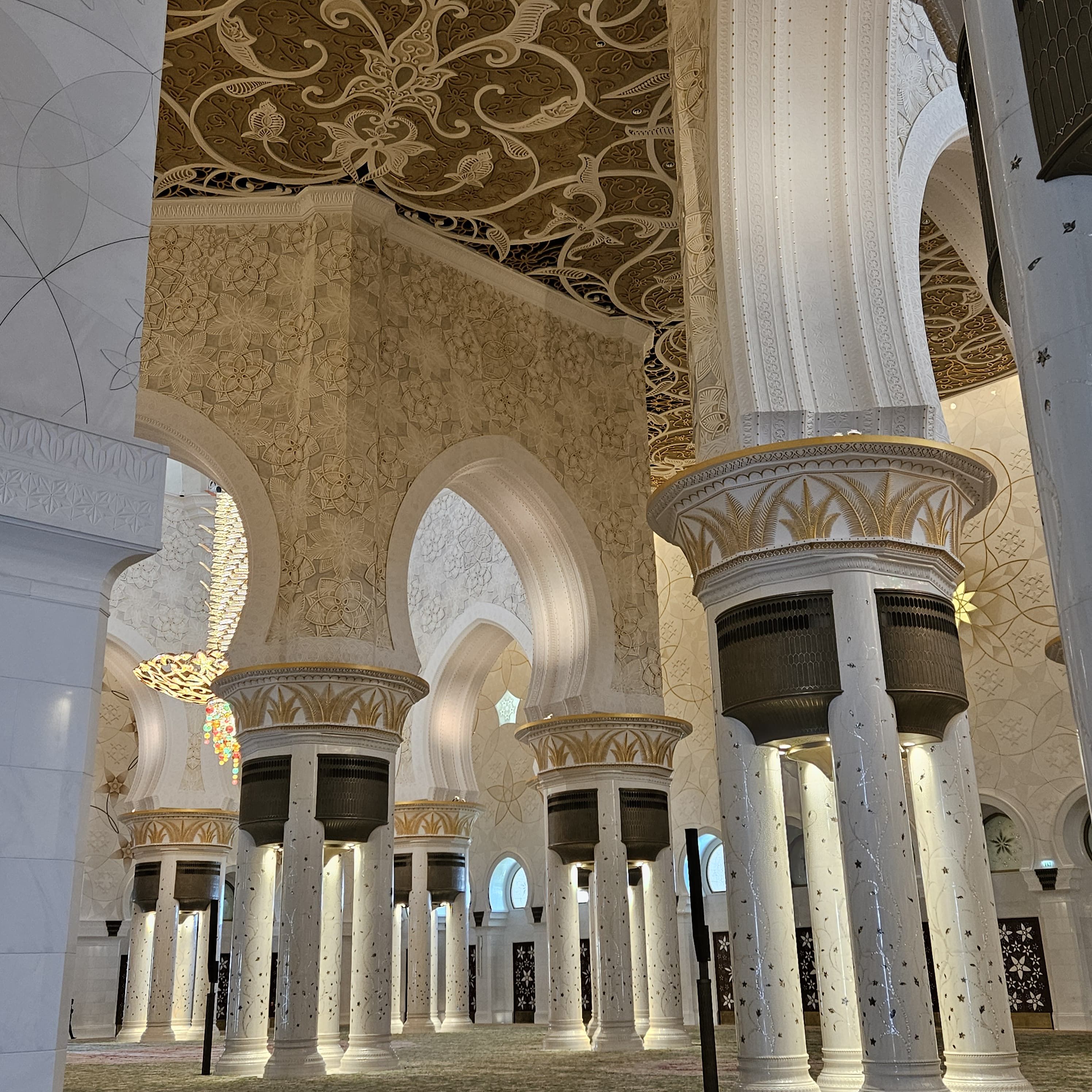 Stunning interior view of the grand mosque, showcasing intricate designs and majestic columns.
