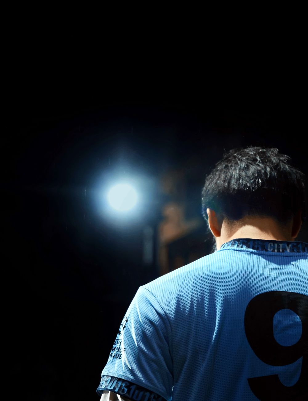 Athlete wearing the Purity Performance Jersey under stadium spotlight