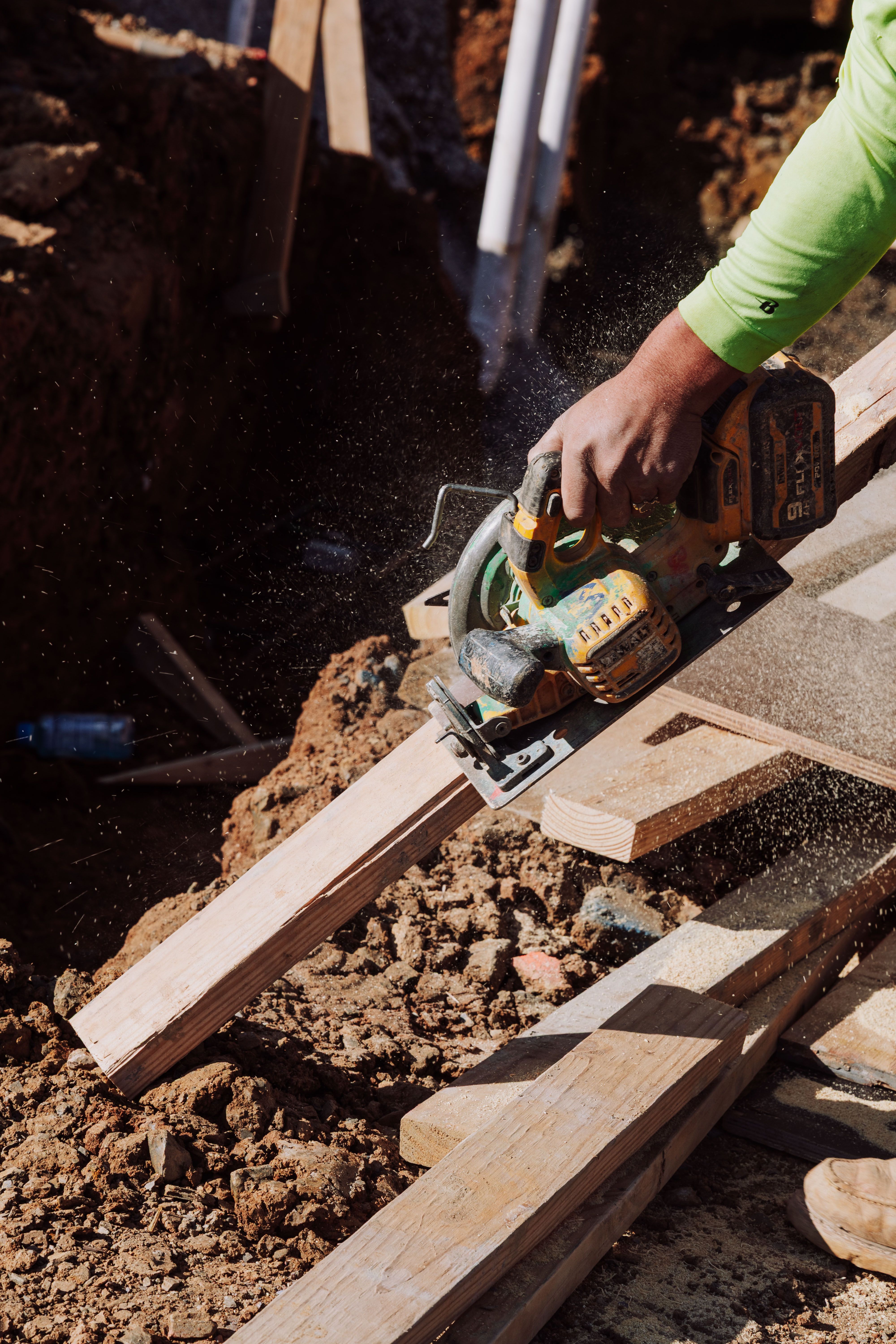 Construction Worker Cutting Timber with Circular Saw · Free Stock Photo