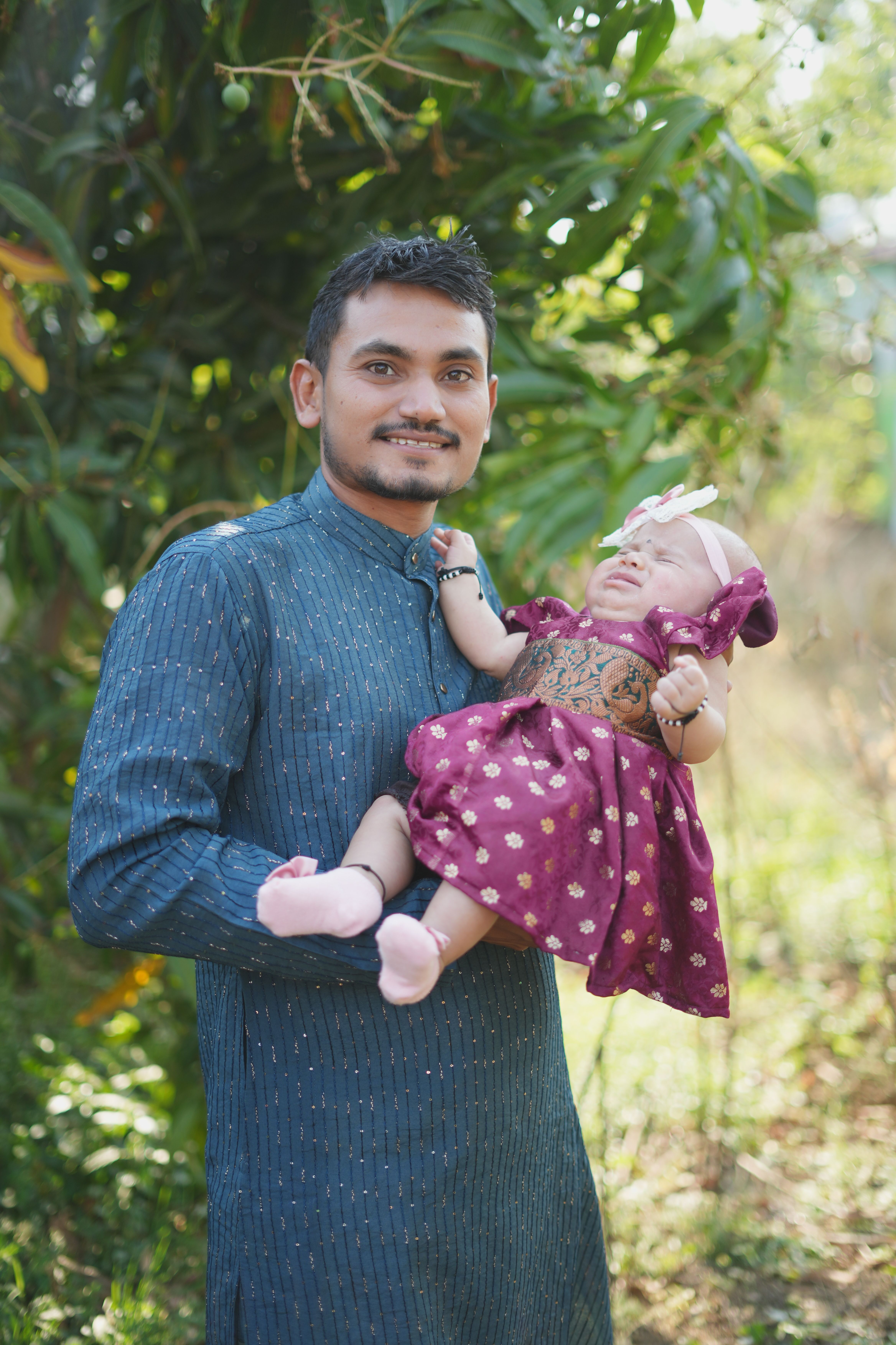 Father Holding Baby in Traditional Indian Attire · Free Stock Photo