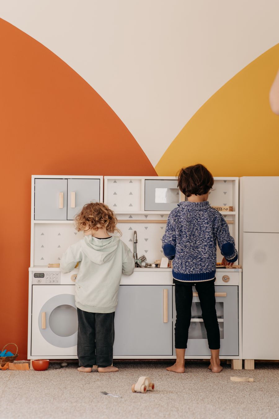 Kids with a toy kitchen