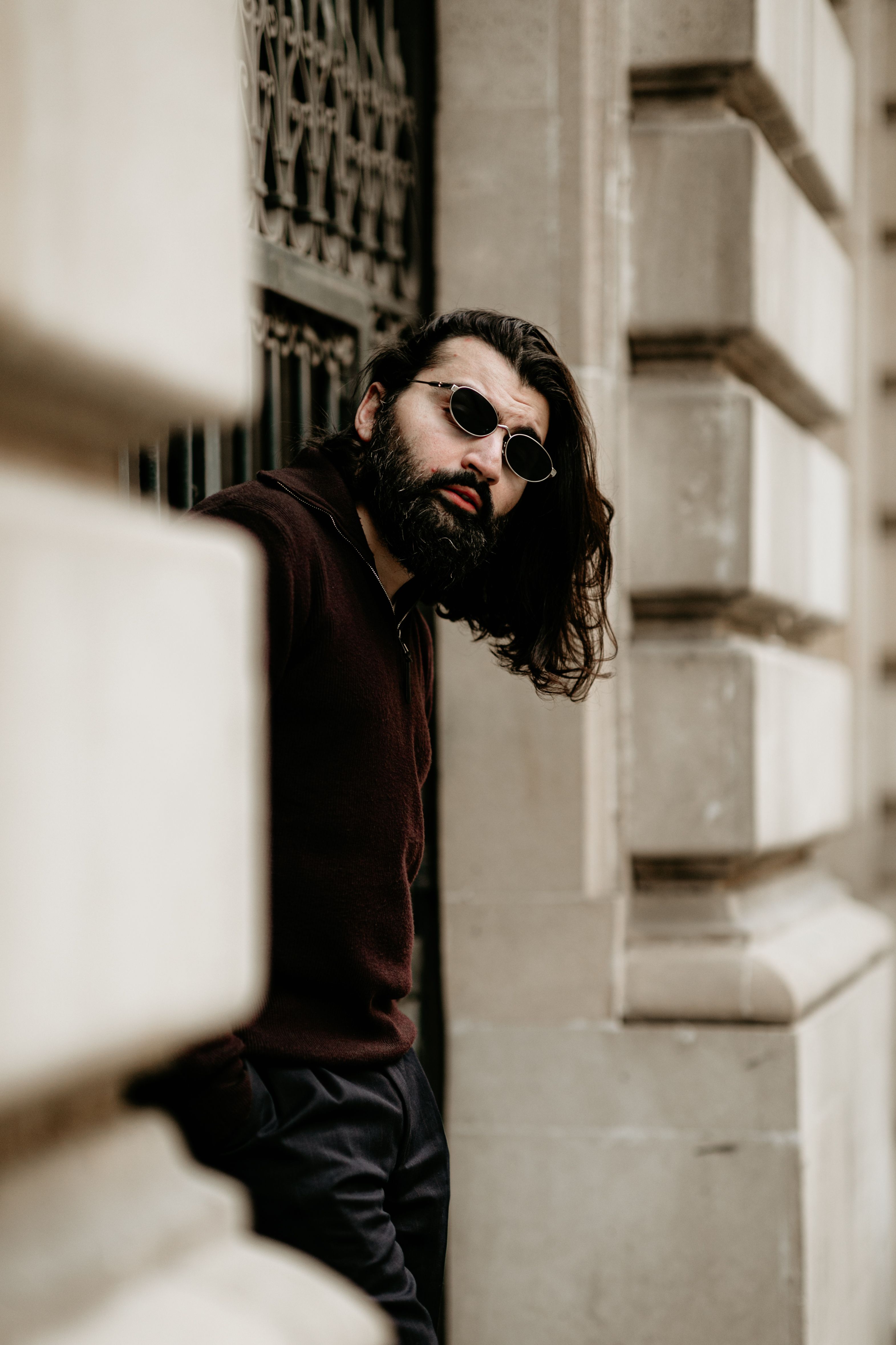 Stylish Man with Sunglasses Leaning on City Wall · Free Stock Photo