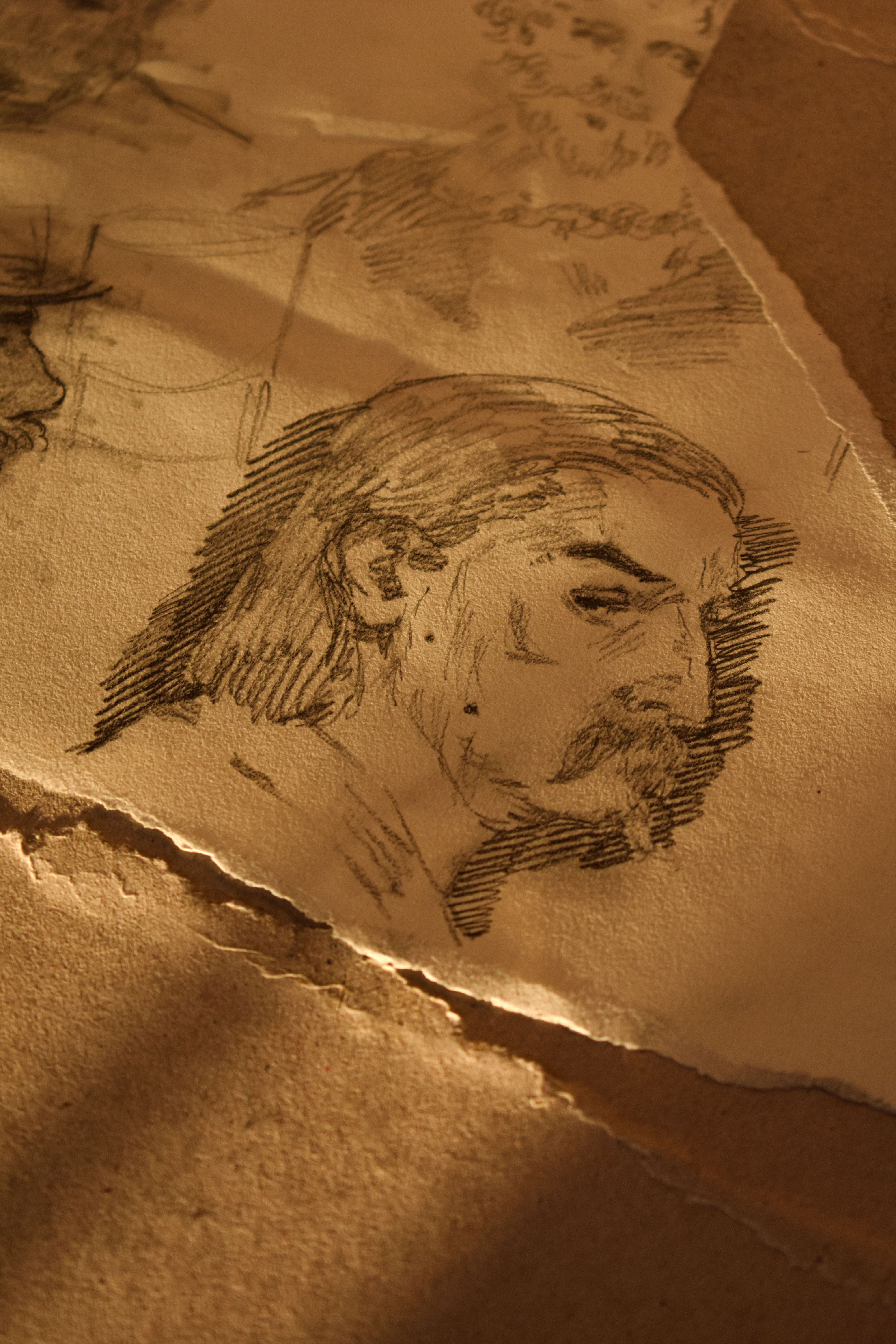 Charcoal pencil sketch of a man, capturing a classic artistic essence on textured paper.