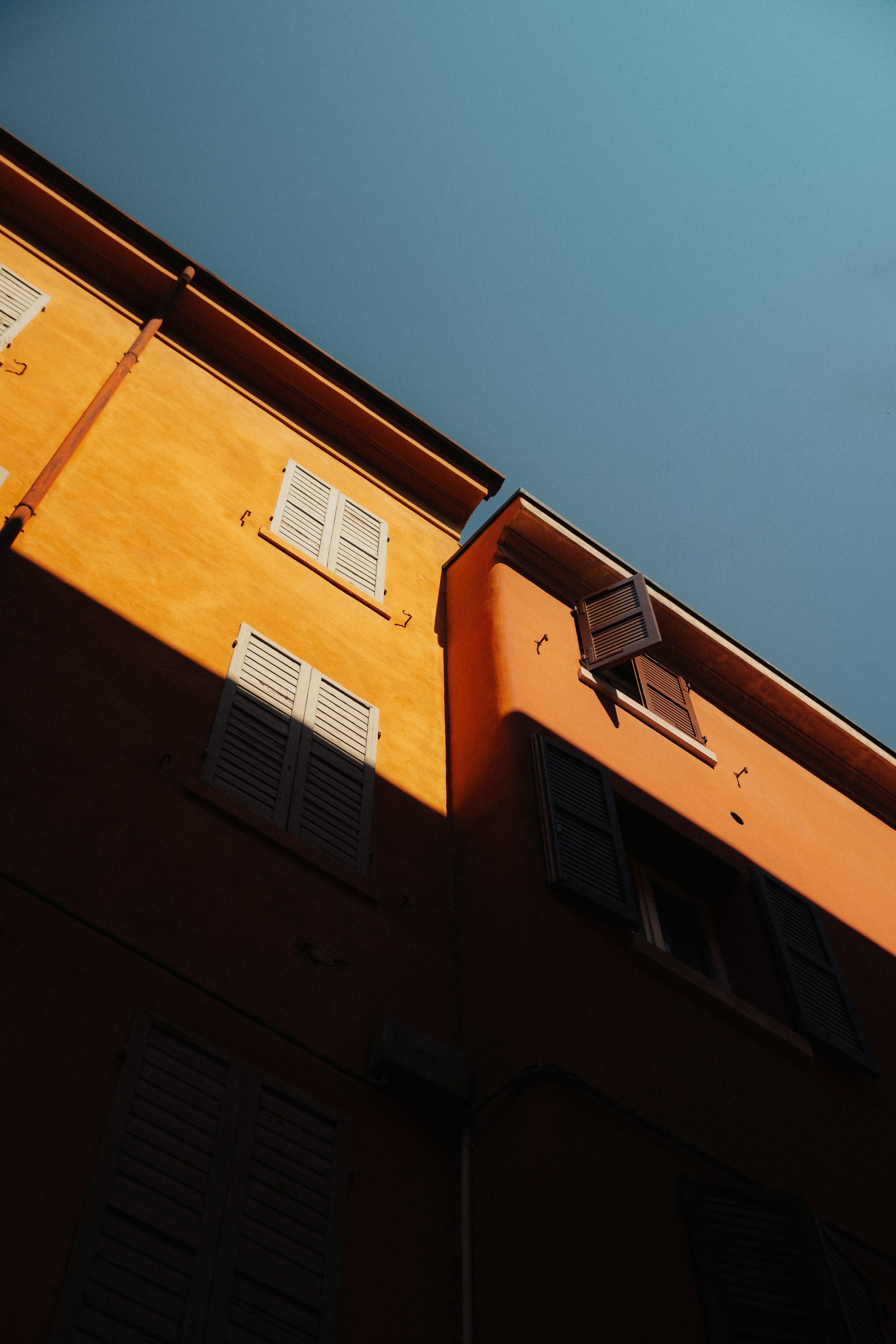 Charming building facade in Modena, Italy, featuring warm colors and contrast lighting.