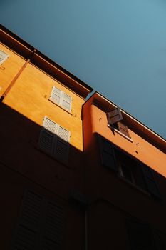 Charming building facade in Modena, Italy, featuring warm colors and contrast lighting.