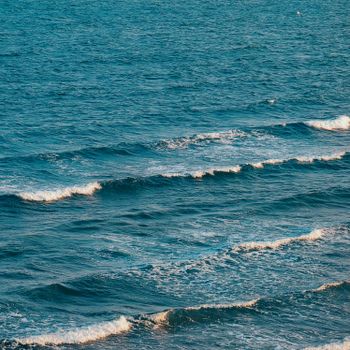 Gentle waves form a serene pattern off the coast of Phan Rang, Vietnam, embodying the calm beauty of the ocean.