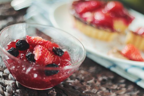 Free Close-up of a fresh berry dessert with strawberries and blackberries in a glass bowl. Stock Photo