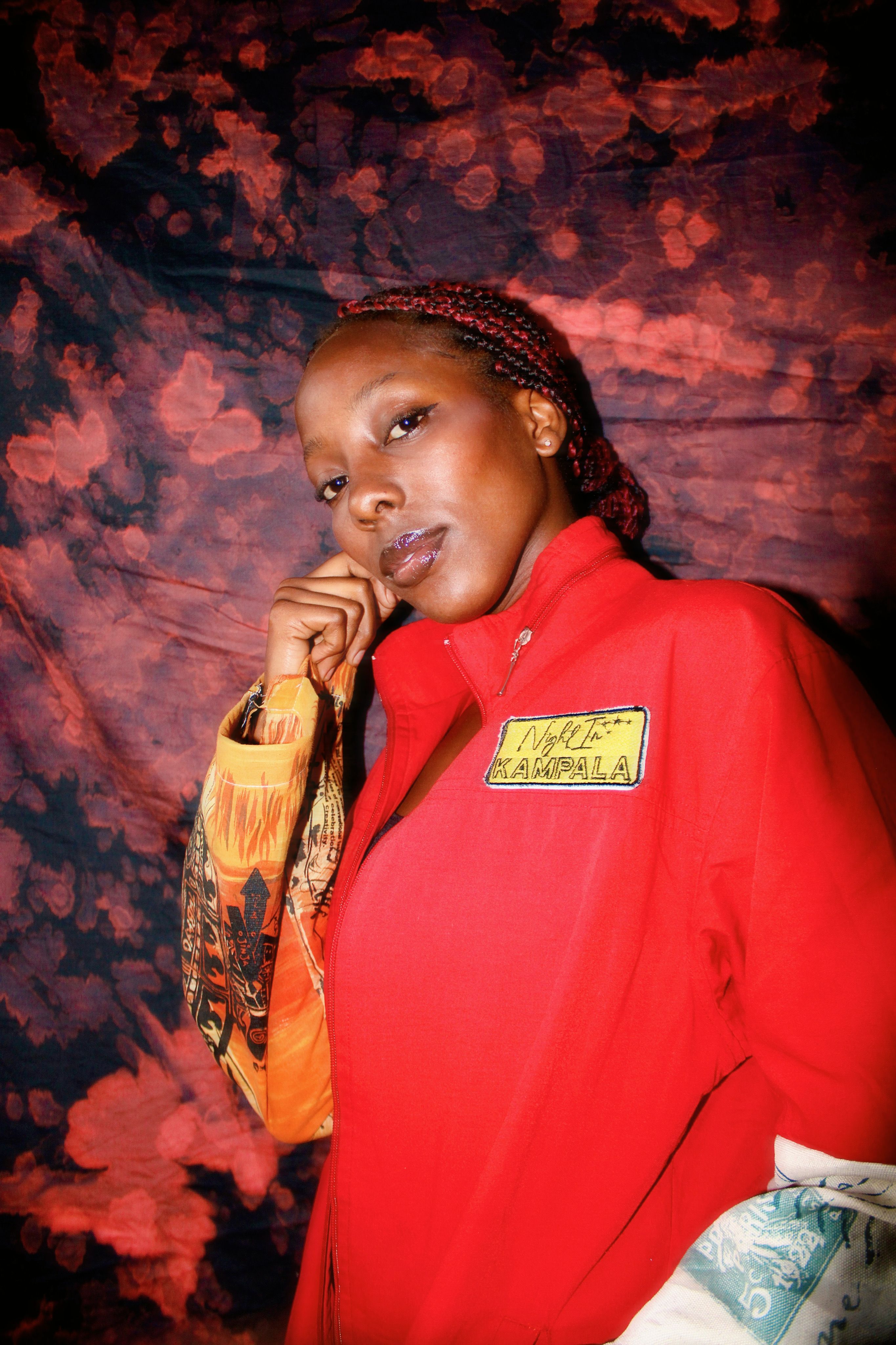 Vibrant portrait of a fashionable woman in a red jacket with artistic background.