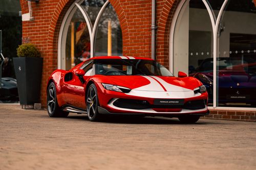 Free A striking red Ferrari parked outside a Southampton showroom, showcasing luxury and performance. Stock Photo
