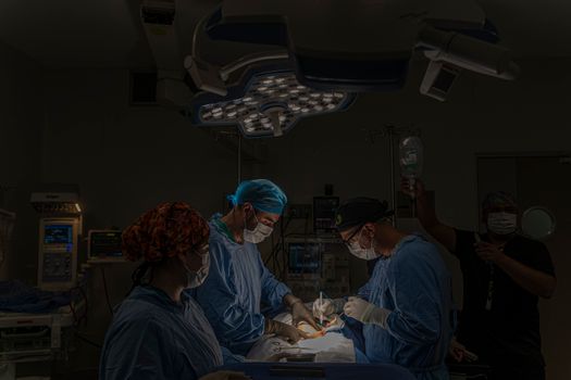 A surgical team conducts an operation in a well-equipped hospital operating room in Mexico.