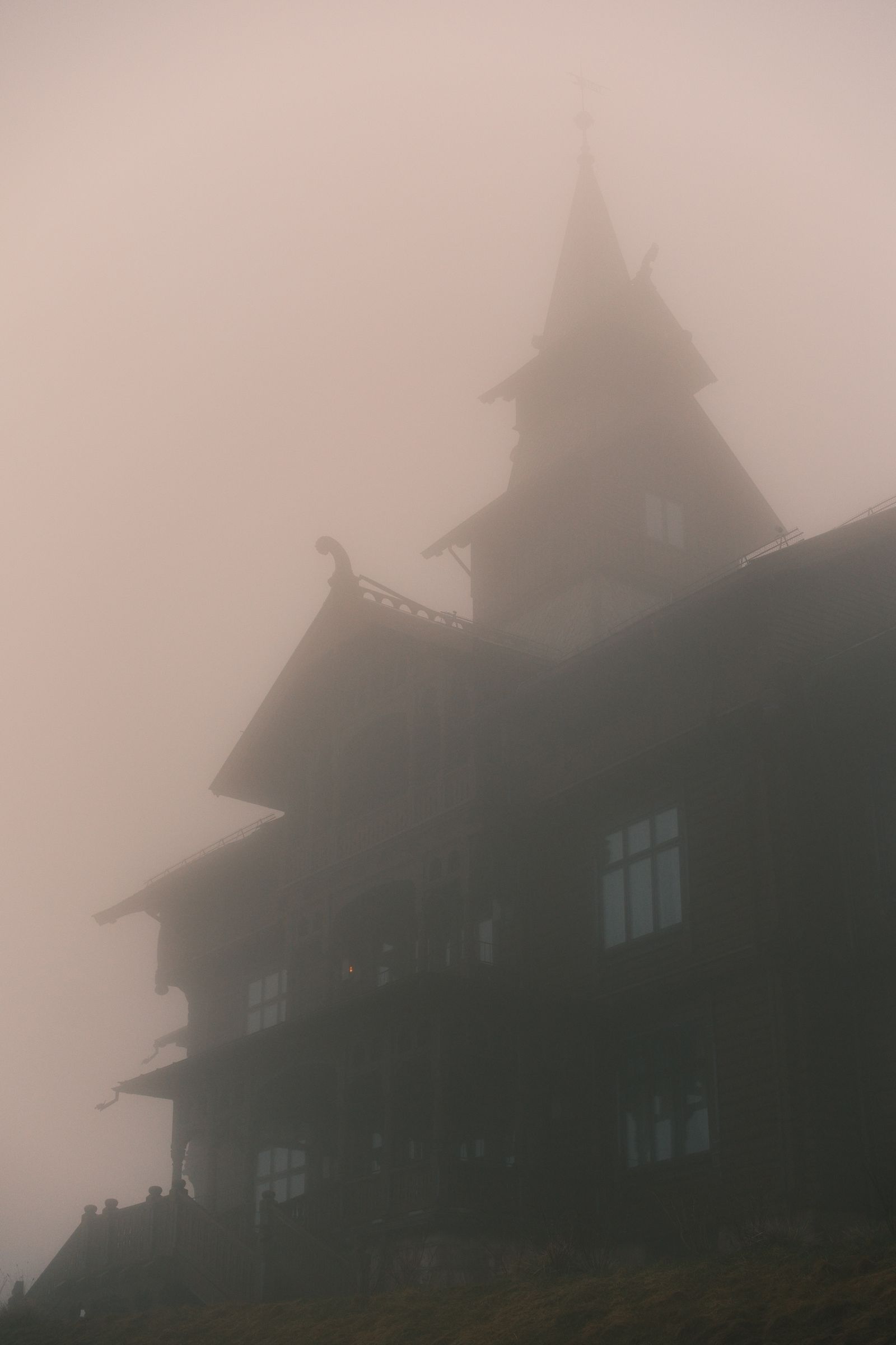 Dark Gothic European architecture surrounded by mist