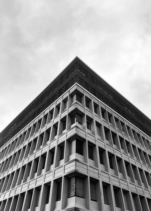 Free Monochrome shot of a modern building in Geneva. Unique angled perspective creates striking architecture view. Stock Photo