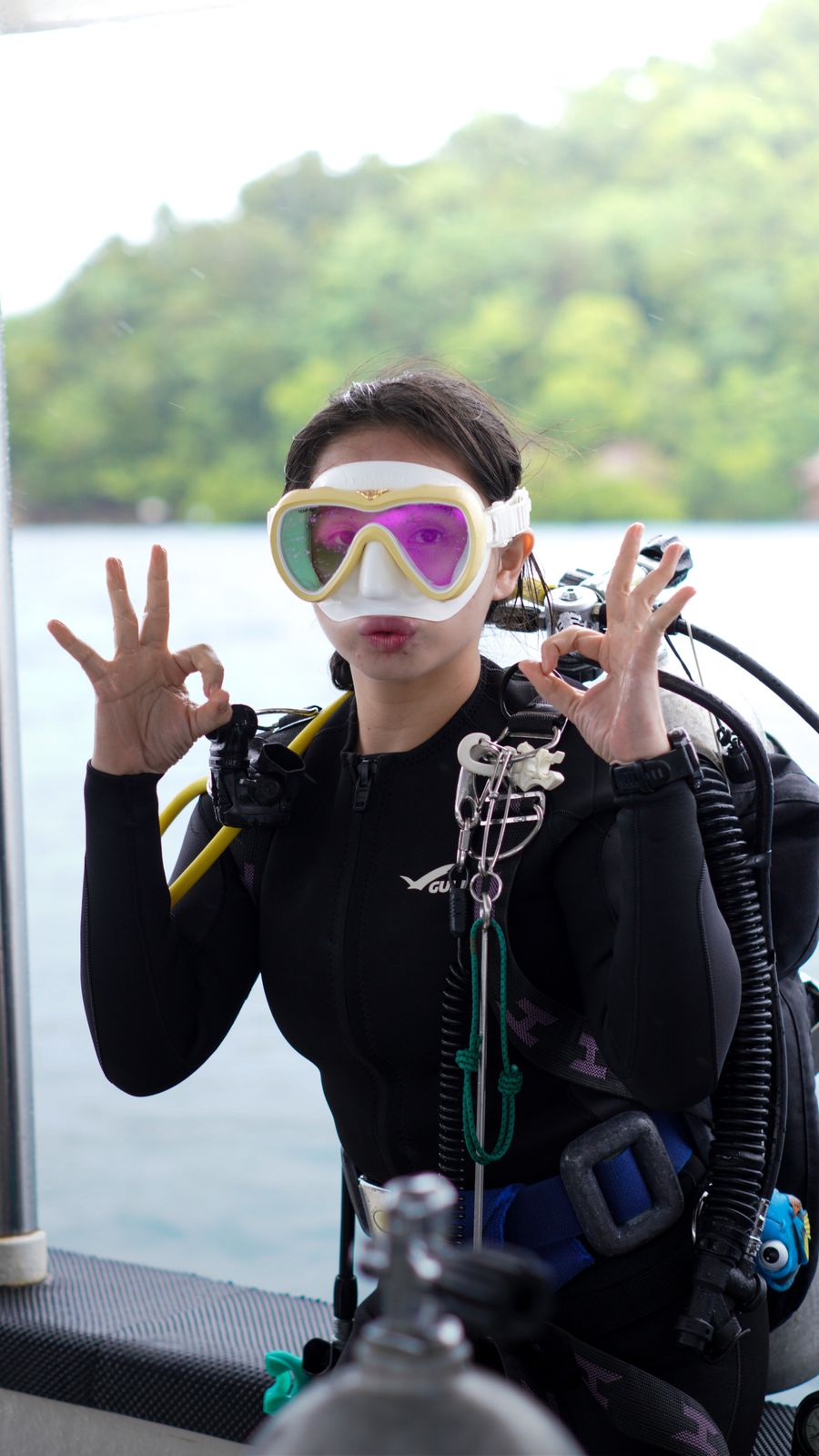 Scuba diving instructor giving OK sign underwater