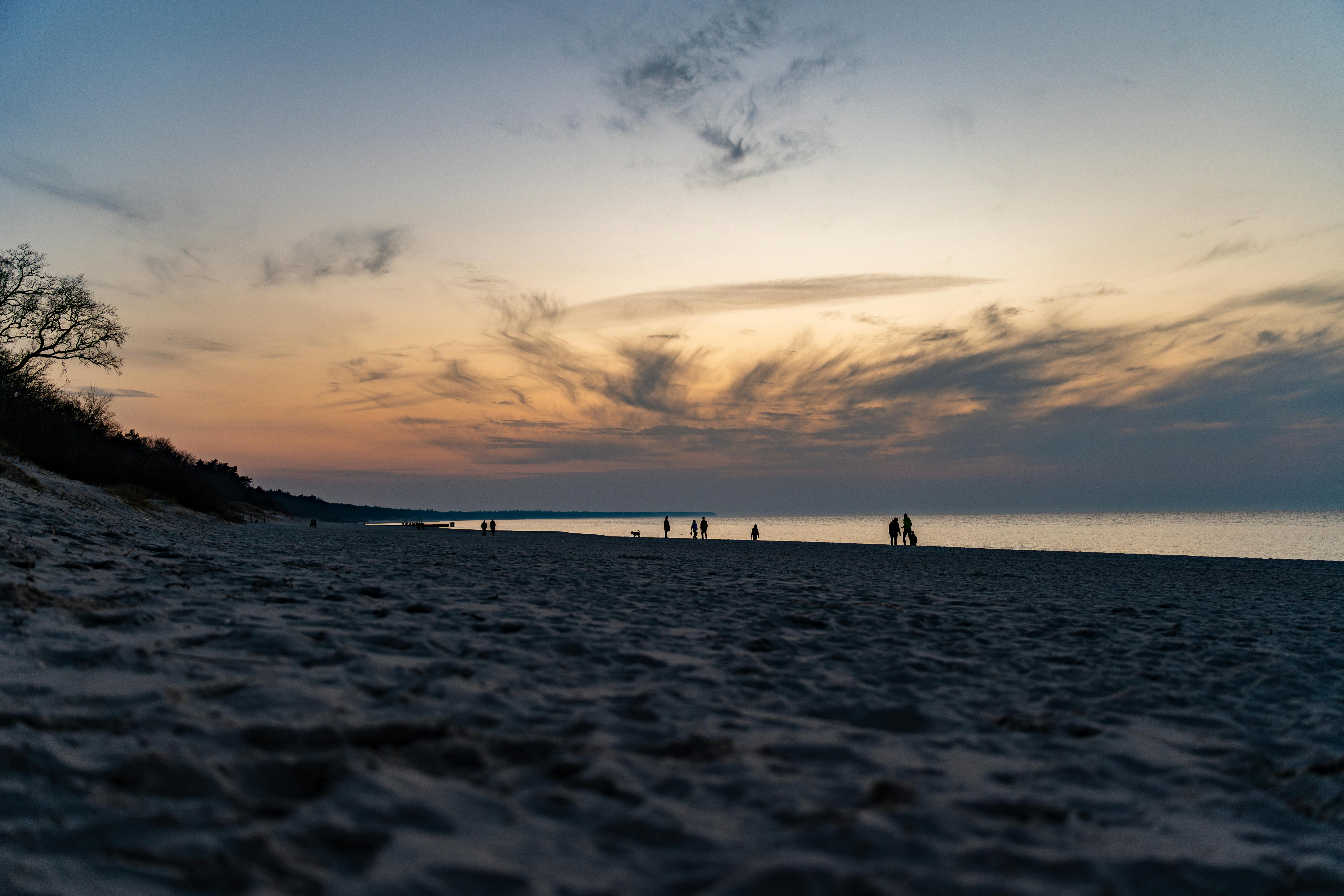 Serene Goan beach with golden sand, palm trees, and a traditional wooden fishing boat under a clear blue sky, evoking the peaceful Easter atmosphere