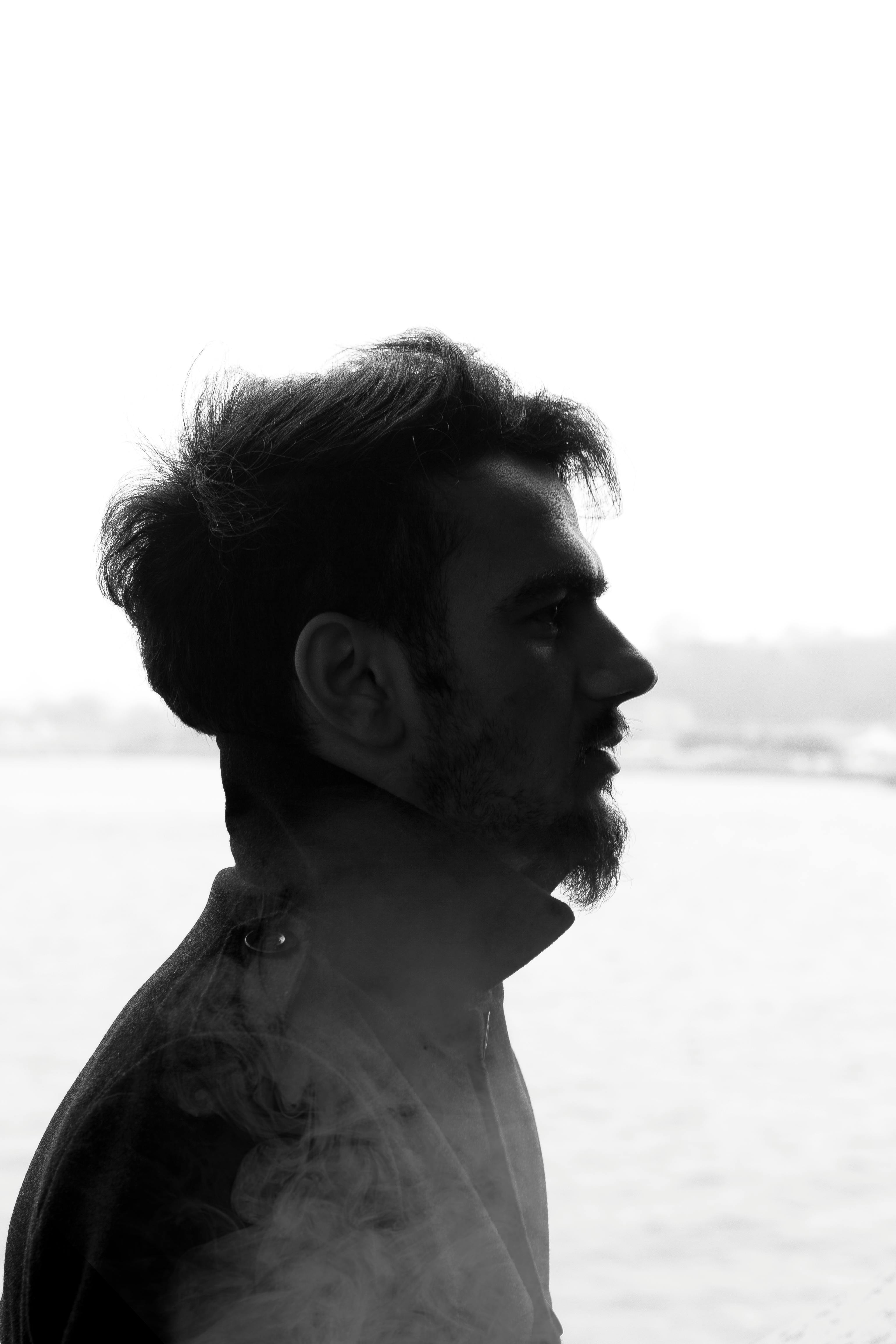 Black and white silhouette portrait of a man by the Bosphorus in Istanbul.