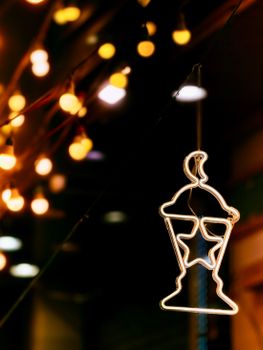 A glowing lantern with bokeh lights at night in Alexandria, Egypt, creating a vibrant and festive atmosphere.