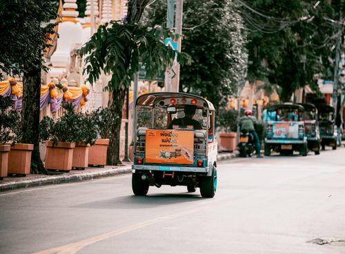 Free Vibrant Bangkok street filled with colorful tuk tuks showcasing urban transportation in Thailand. Stock Photo