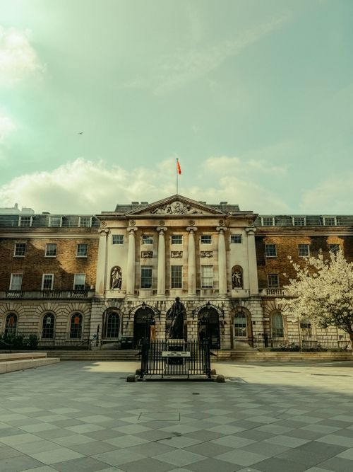 Free Elegant historic building with statue in London, under a bright sky. Stock Photo