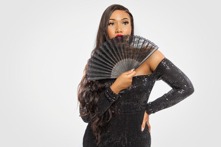 Woman In Black Long Sleeve  Dress Holding Black Hand Fan