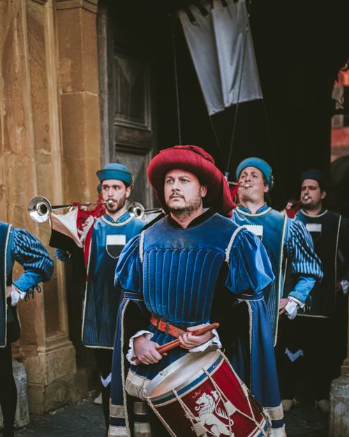 Free Colorful procession of musicians in traditional blue costumes playing drums and trumpets. Stock Photo