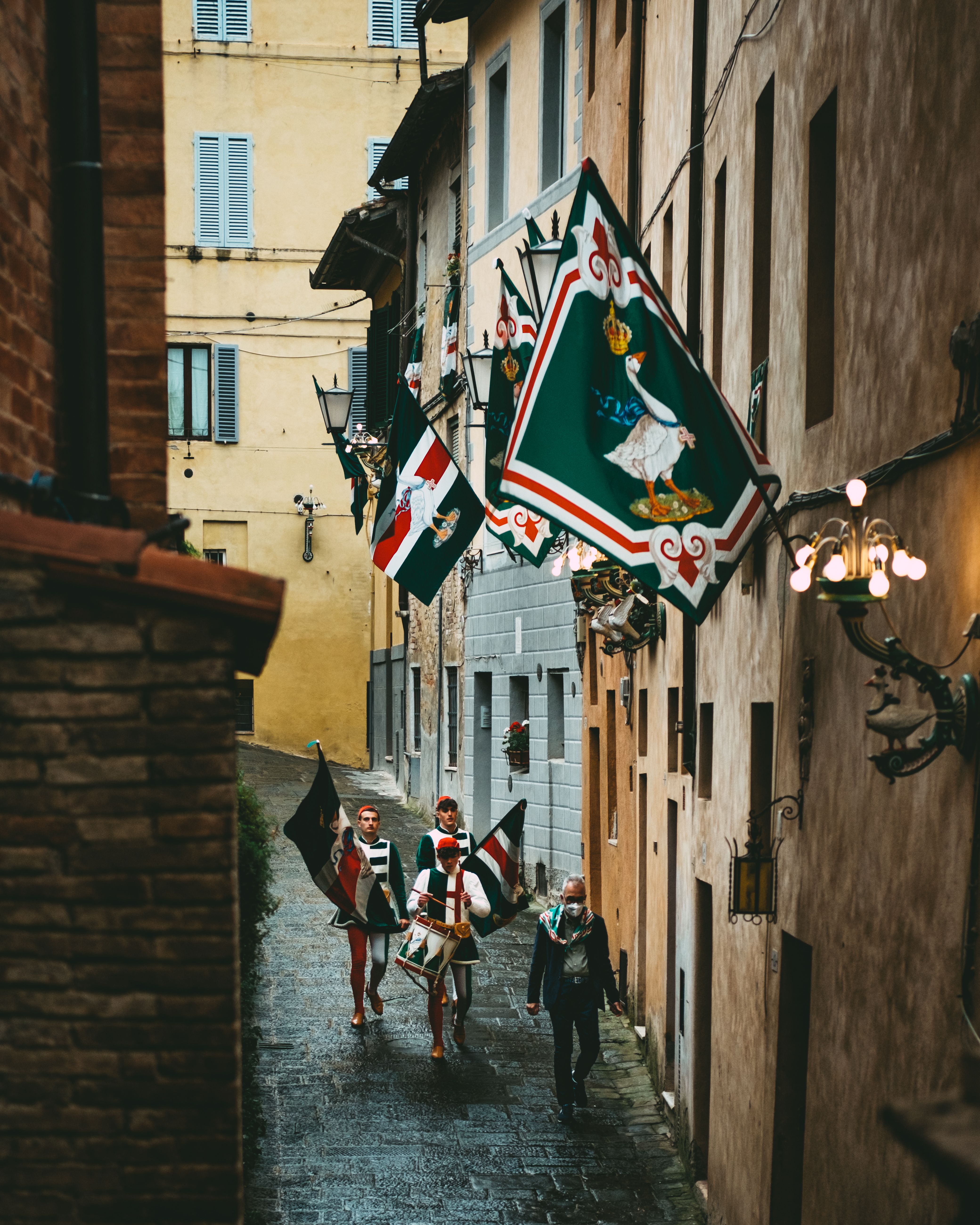 Traditional Parade in Historic European Alleyway · Free Stock Photo