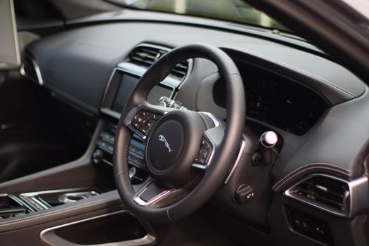 Stylish interior of a luxury car featuring a sleek dashboard and modern controls for a premium driving experience.