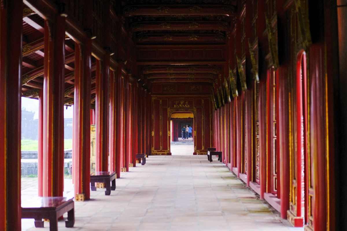Covered corridor with red columns inside the Hue Imperial City