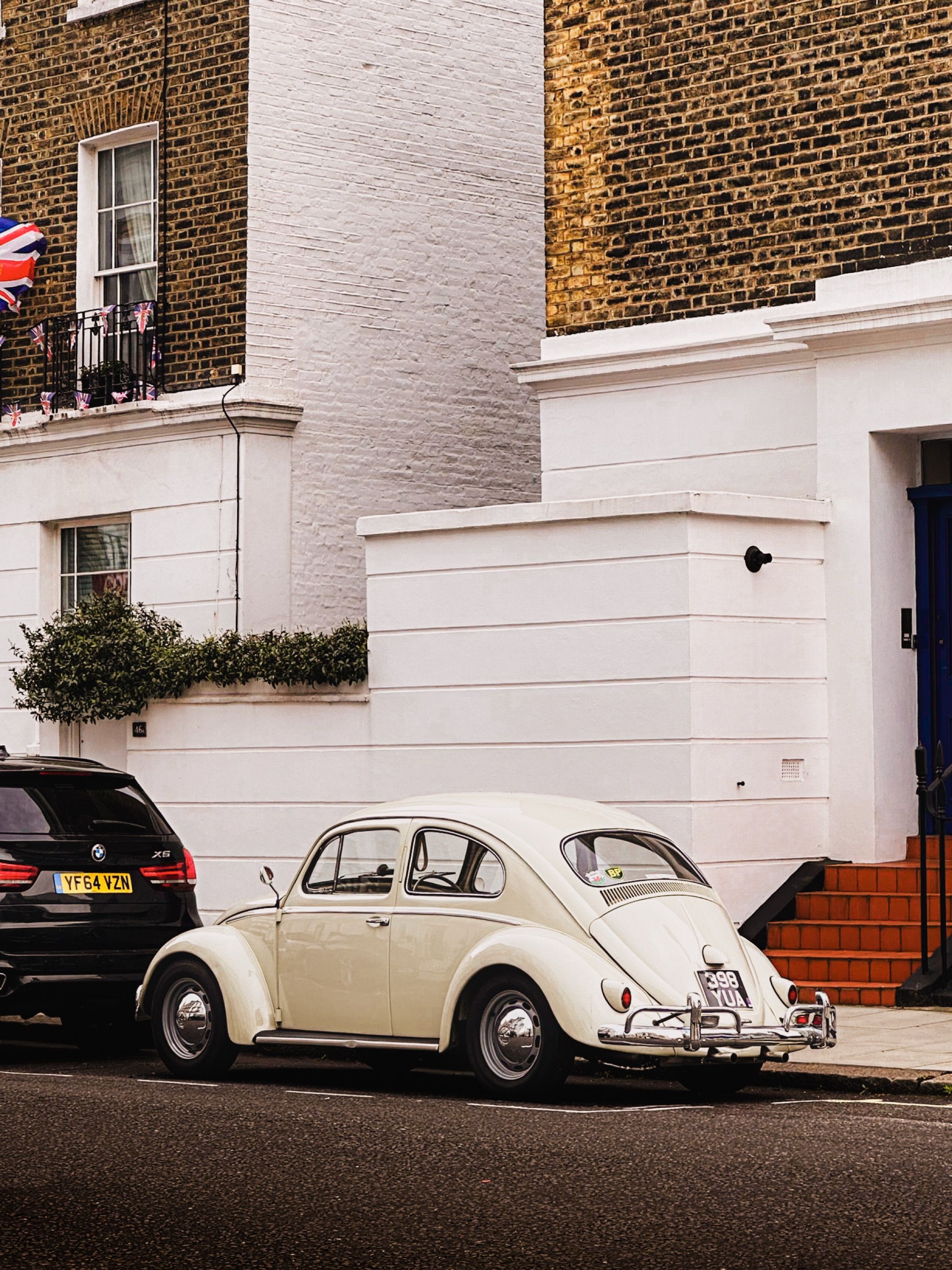 Photo of Parked Volkswagen Beetle in front of Residential Building ...