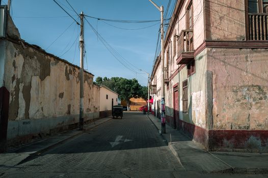 A tranquil street in Trujillo, Peru showcasing rustic architecture and urban tranquility.