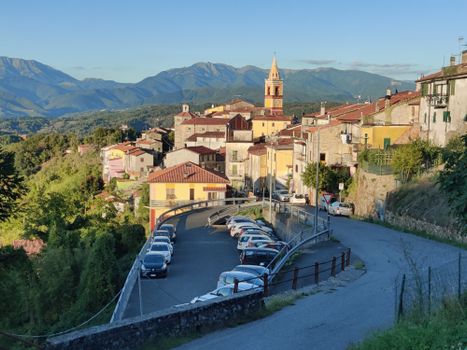 Picturesque view of an Italian village with mountains in the background.