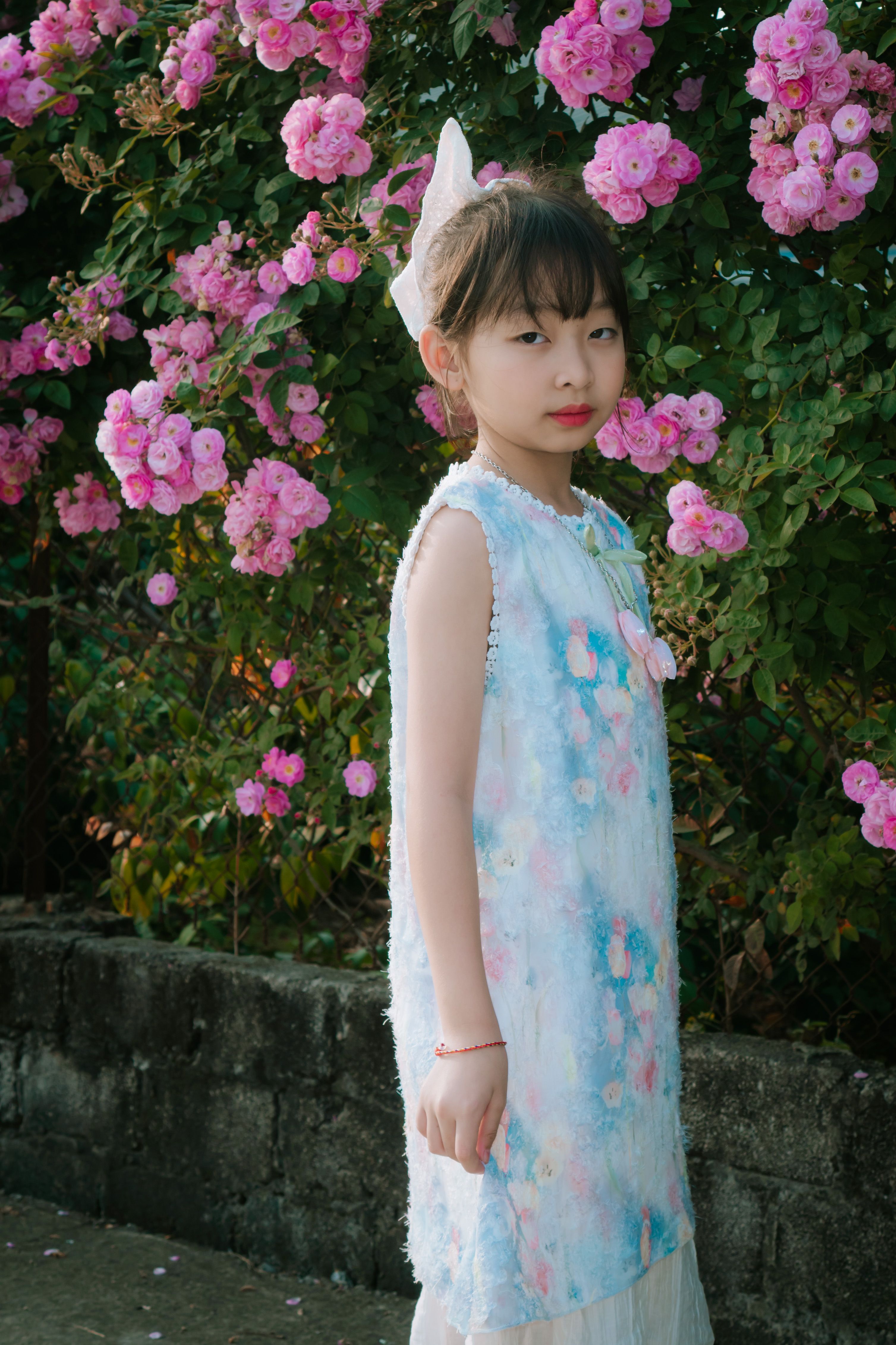 Young Girl in Floral Dress with Pink Roses · Free Stock Photo