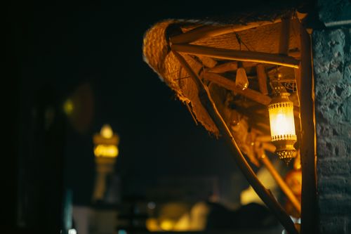 Free Warmly lit traditional lanterns hanging in Bukhara, Uzbekistan at night. Stock Photo