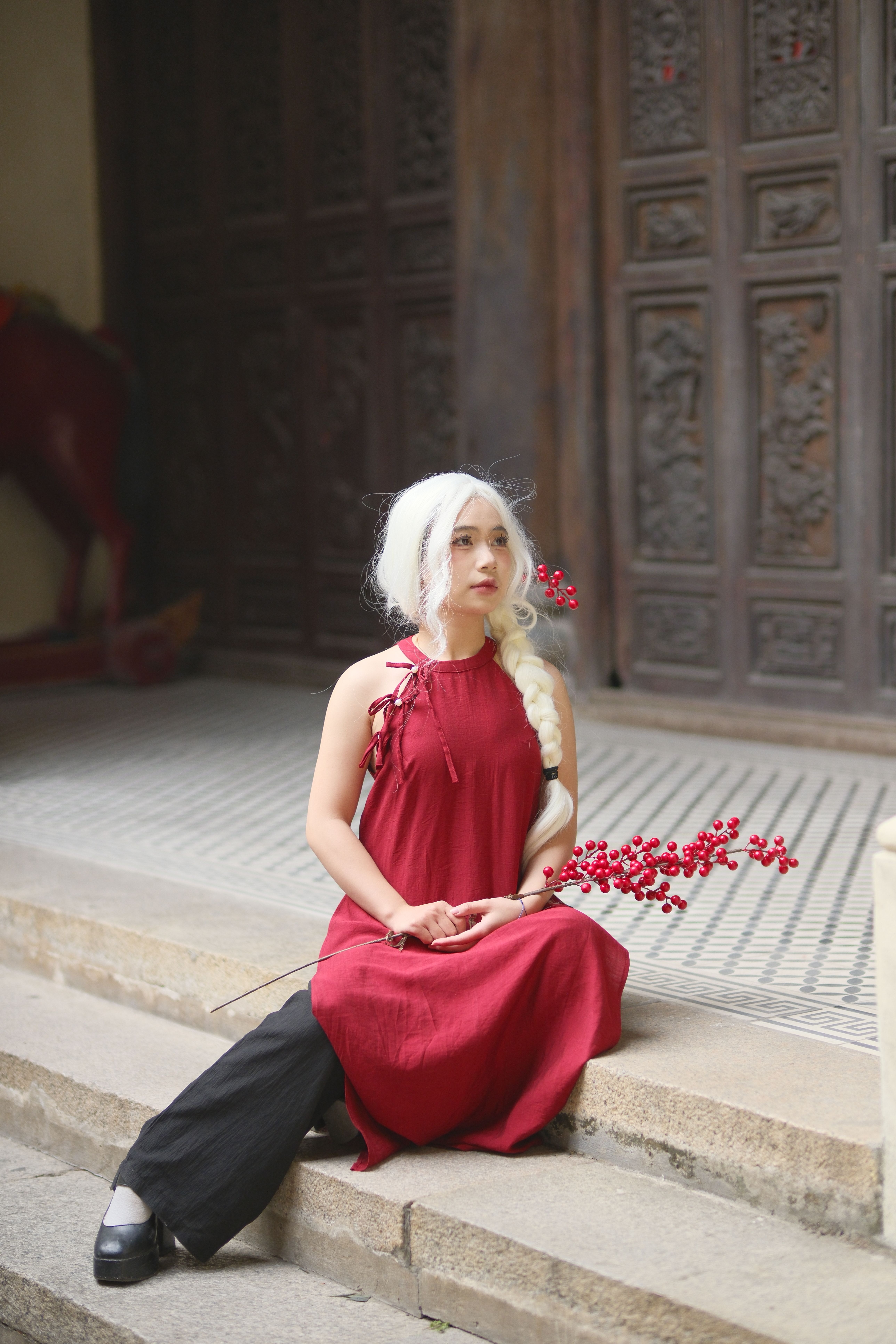 Woman in Red Dress Sitting on Stone Steps Outdoors · Free Stock Photo