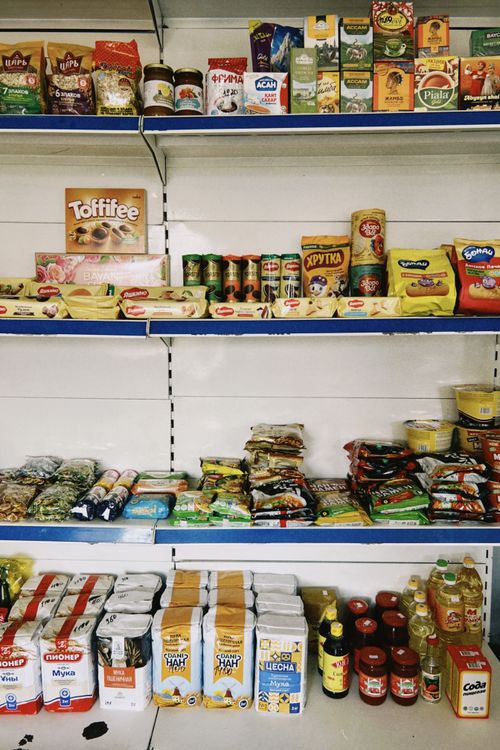 Free A neatly organized grocery store shelf displaying various packaged goods in Talgar, Kazakhstan. Stock Photo