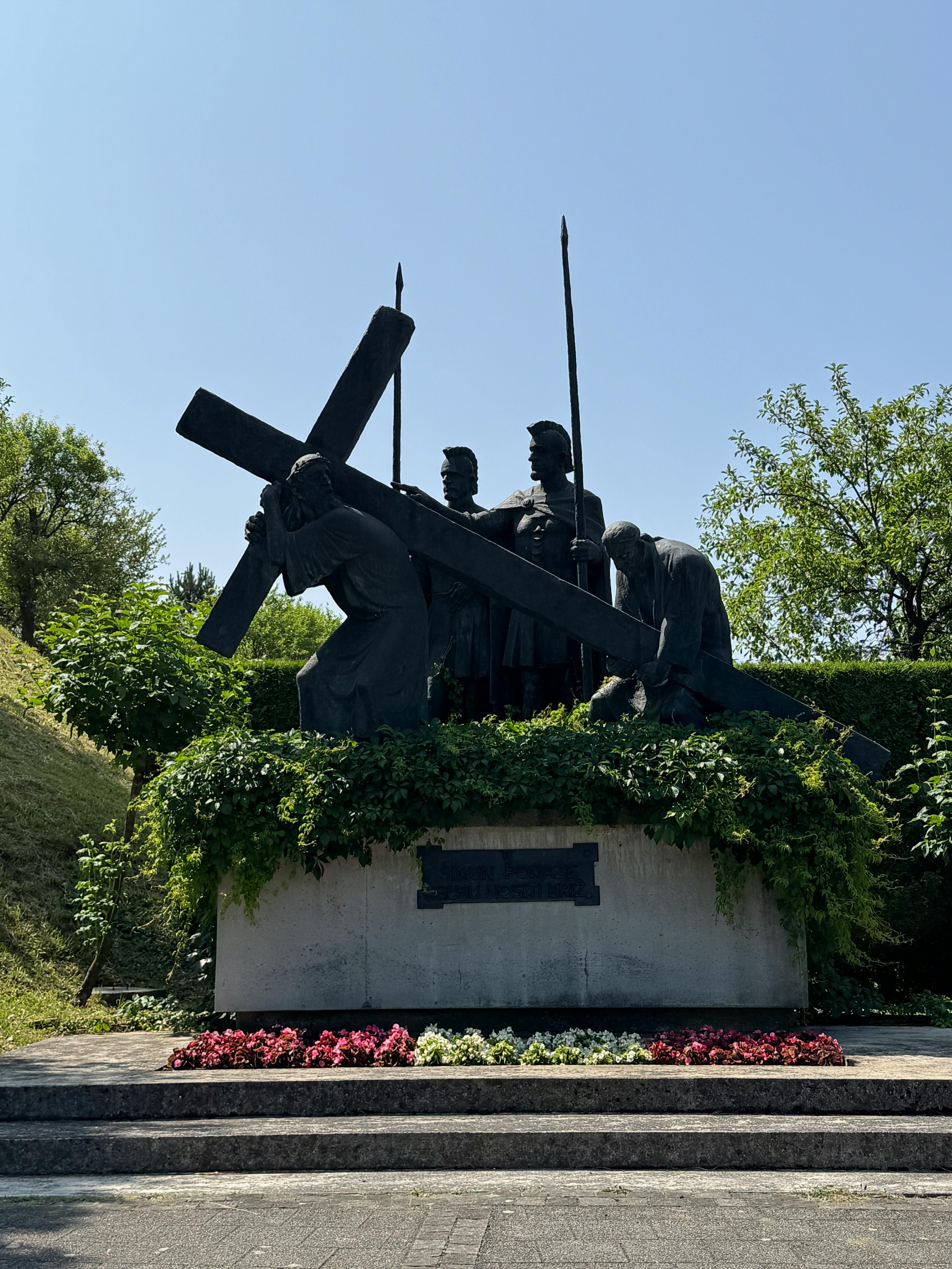 Sculpture depicting a religious procession with figures carrying a cross in Marija Bistrica, Croatia.