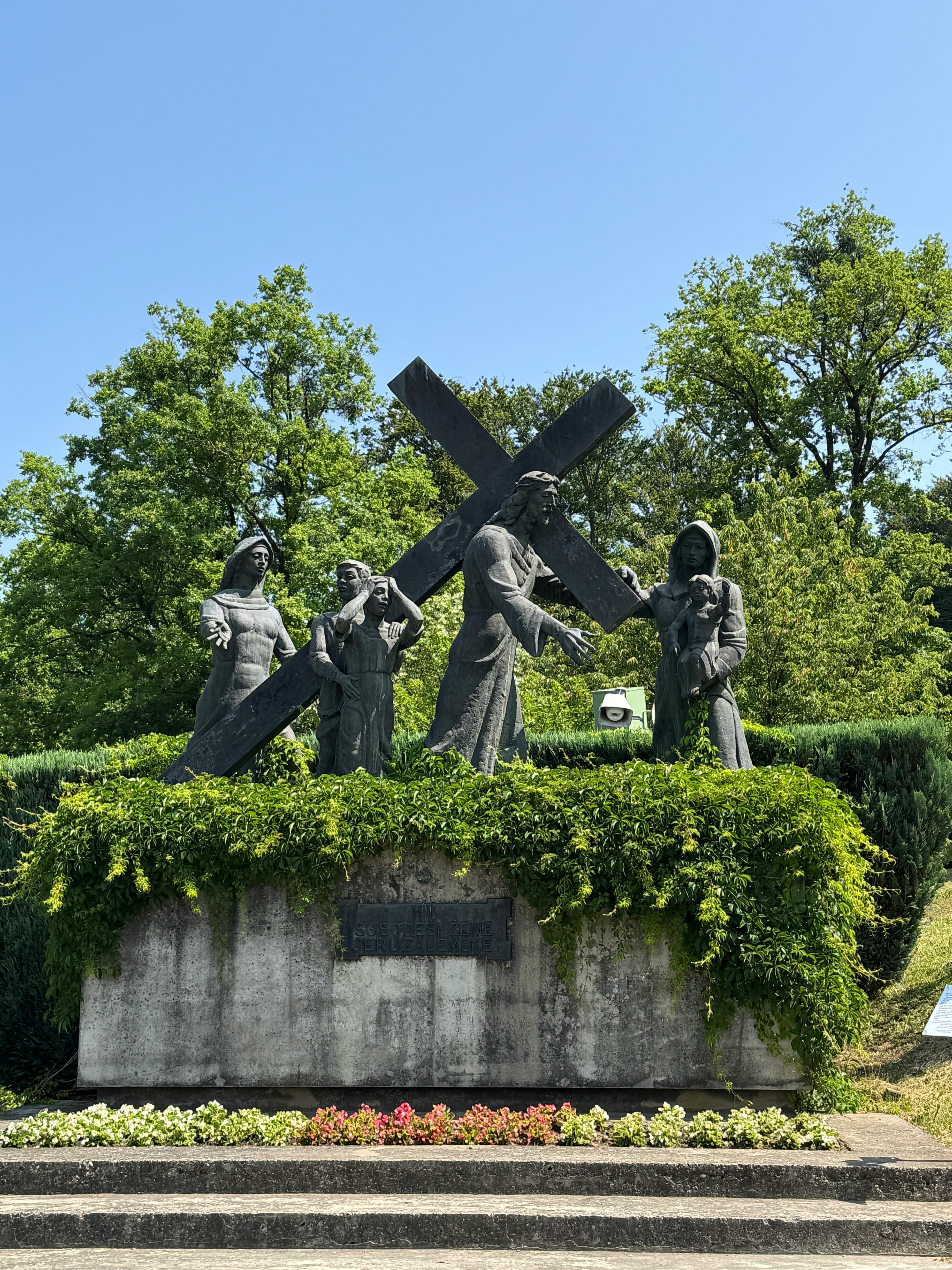 Sculpture of religious figures and cross at Marija Bistrica, Croatia on a sunny day.